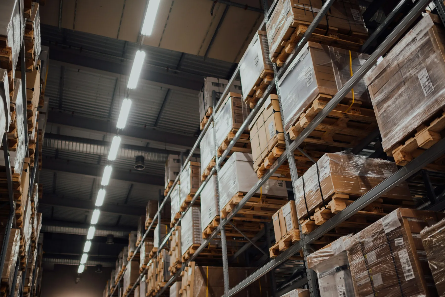 Pallets of goods stored on tall warehouse racks